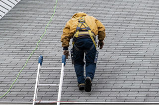 Man on roof after climbing ladder